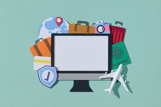 Travel elements in paper cut style with blank screen of computer