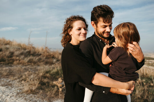 Family Embrace on Hillside at Dusk