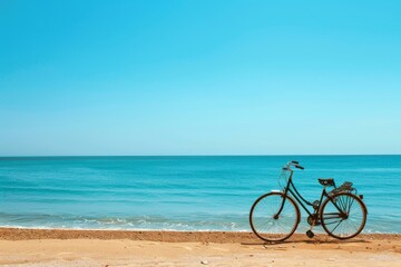Fototapeta premium Black bicycle is standing on a beautiful beach with turquoise water and blue sky