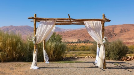a wedding ceremony nestled amidst desert landscape, with a wooden canopy adorned with white linen curtains, vibrant flowers, and lush greenery, providing seating for guests under the open sky.