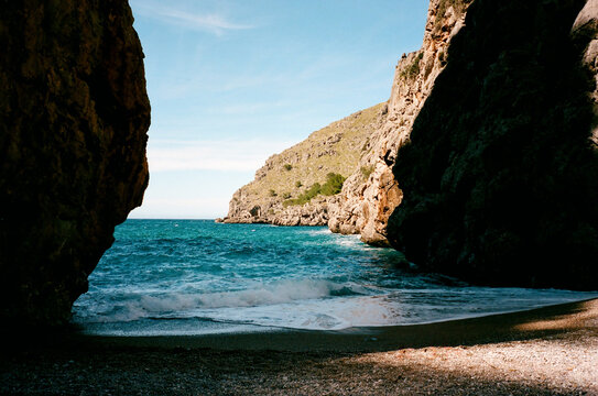 Film photo Serene Beach Between Rocky Cliffs. Mallorca, Spain