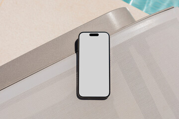 Mockup Smartphone with white screen at Sunny Poolside