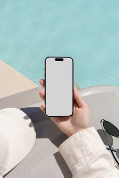 Mockup Smartphone with white screen at Sunny Poolside