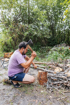 Man Chopping Wood in Forest