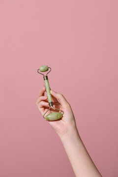 Beautiful female hand holding jade roller