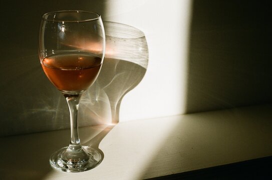 Wine glass in sunlight with shadow