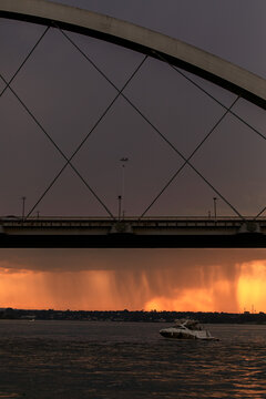 Sunset over the Paranoa Lake with rain in the background