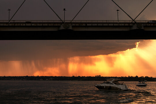 Sunset over the Paranoa Lake with rain in the background
