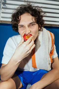 Man biting fruit in summer day ugc