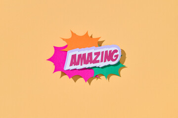 Decorative text AMAZING on beige background with speech bubble.