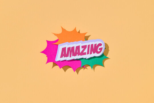 Decorative text AMAZING on beige background with speech bubble.