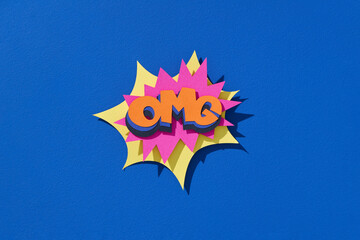 Colorful explosive OMG sign on a blue background