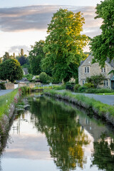 river through a cotswolds village