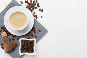 Cup of coffee made using pyramid on concrete background, top view