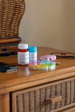 Prescription pills on table with eyeglasses  