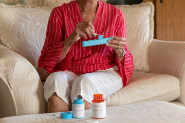 Woman holding prescription pill organizer in hand sorting pills