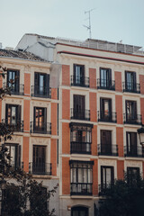 Facade of a traditional apartment block building in Old Town in Madrid, Spain.