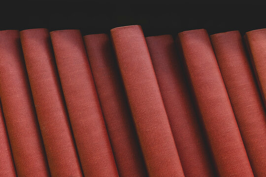 Row of red periodical books on shelf, close up