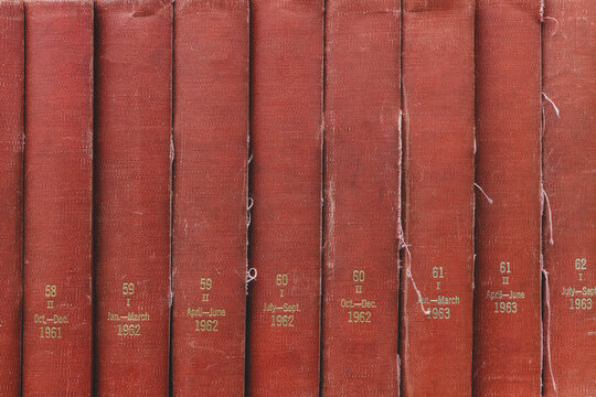 Row of old and tattered red periodical books