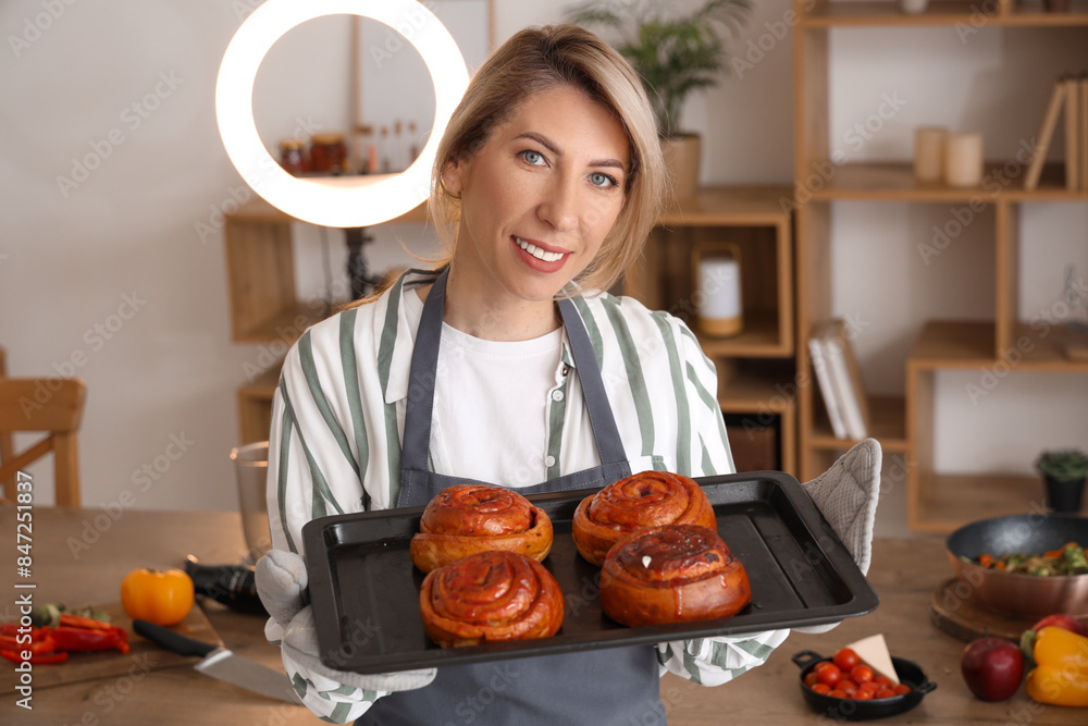 Sticker Female food blogger with tasty buns recording video in kitchen