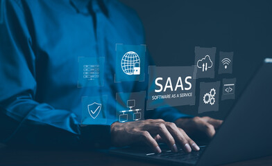 SaaS Concept, Software as a Service, A man types on laptop with digital icons representing various...