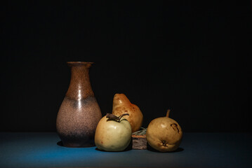 Still life, plenty of space for text. Empty vintage brown ceramic vase and next to them green apple...