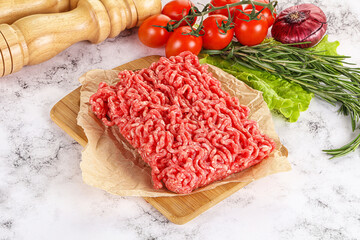 Raw minced beef meat on cutting board