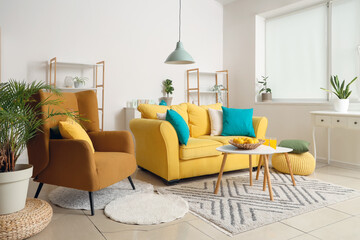 Interior of beautiful living room with yellow sofa, coffee table, armchair and shelving unit