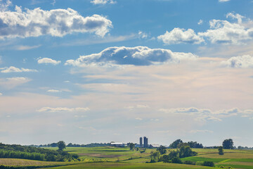 Iowa farm and fields under a beautiful cloudscape on a sunny summer afternoon © Daniel Thornberg