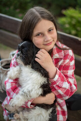 Teenage Girl with a Shih Tzu Dog. 10-Year-Old Girl with a Black and White Shih Tzu