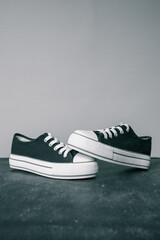 Black and white sneakers on a gray background