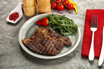 Grilled chuck roll steak with arugula