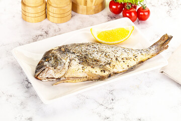 Baked Dorado fish served lemon