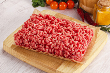 Raw minced beef meat over board