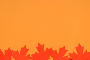 Maple leaves on orange background. Canada Day concept