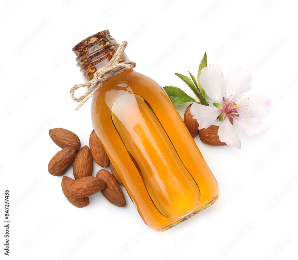 Wall mural bottle of almond oil, fresh nuts and beautiful flower isolated on white, top view - Wall murals