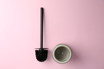 Toilet brush and holder on pink background, top view