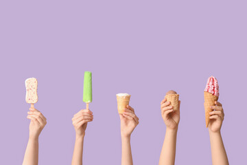 Female hands with different sweet ice-cream on lilac background