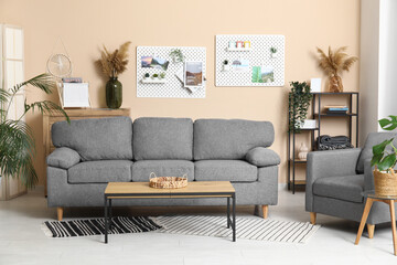 Beautiful living room with comfortable sofa, coffee table and pegboard