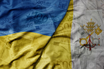 big waving realistic national colorful flag of vatican city and national flag of ukraine on a euro money banknotes background.