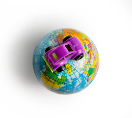 car travel and tourism concept, with miniatures of a car on an earth globe