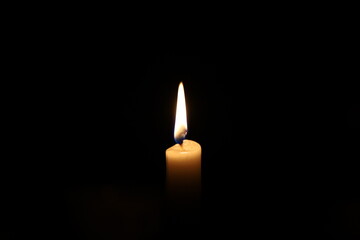 Paraffin candle in complete darkness