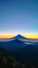 Obraz premium Aerial Drone View of Mountain Silhouette at Sunrise from the Top