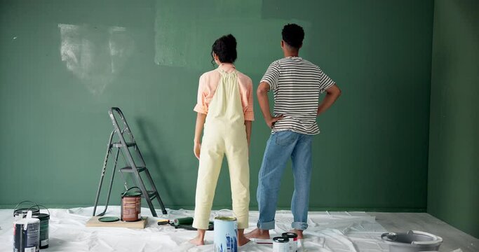 Back, couple and happy with high five for painting on wall in new home or house for renovation. People, relationship and love with fun to enjoy, support and care for teamwork, collaboration and smile
