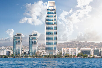 Modern skyscraper standing tall on Limassol city coastline on sunny day. Cyprus