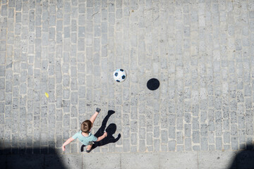 Child Playing Soccer in the Street in Seville, Spain © Felipe Rodríguez