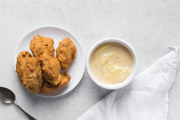 Overhead view of akara and nigerian akamu or pap, flatlay of nigerian akara fried bean cake and akamu ogi pap or corn pudding