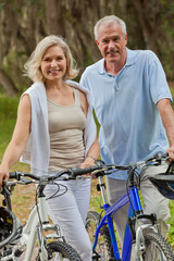 Happy Senior Couple on Bicycles In a Park