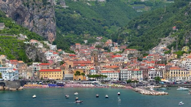 Aerial drone fly of Maiori resort village, Amalfi coast, Italy, Beautiful Italian Villa on a rocky seashore by the Porto di Maiori Aerial drone view of scenic Mediterranean Town with the blue sea. 
