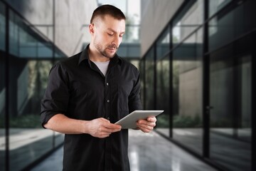 Smiling professional business man standing in office